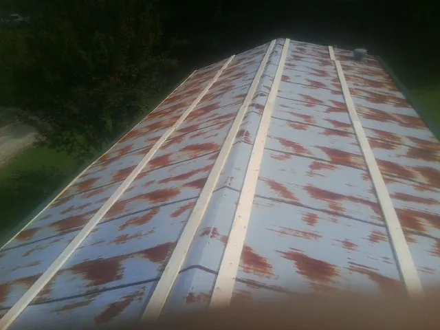 Rusted metal roof panels with new wood purlins before replacement — Storm Damage Roof Repair in Belle Vernon by Roofing Brothers